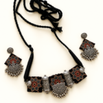 Black-Printed-Fabric-Necklace-Set-with-Silver-Tone-Charms-on-Display