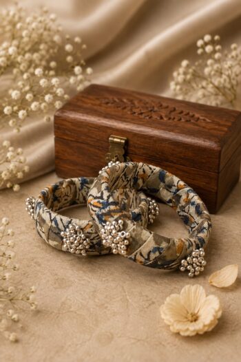 Handcrafted beige Ajrakh fabric bangles with silver bead clusters, set of 2