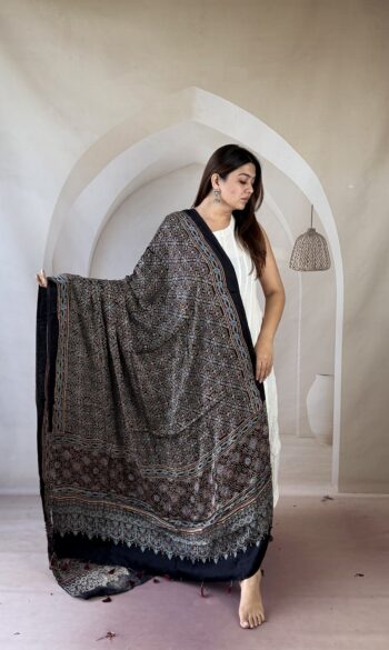 Black Ajrakh modal silk dupatta with geometric star lattice and rust medallion palla