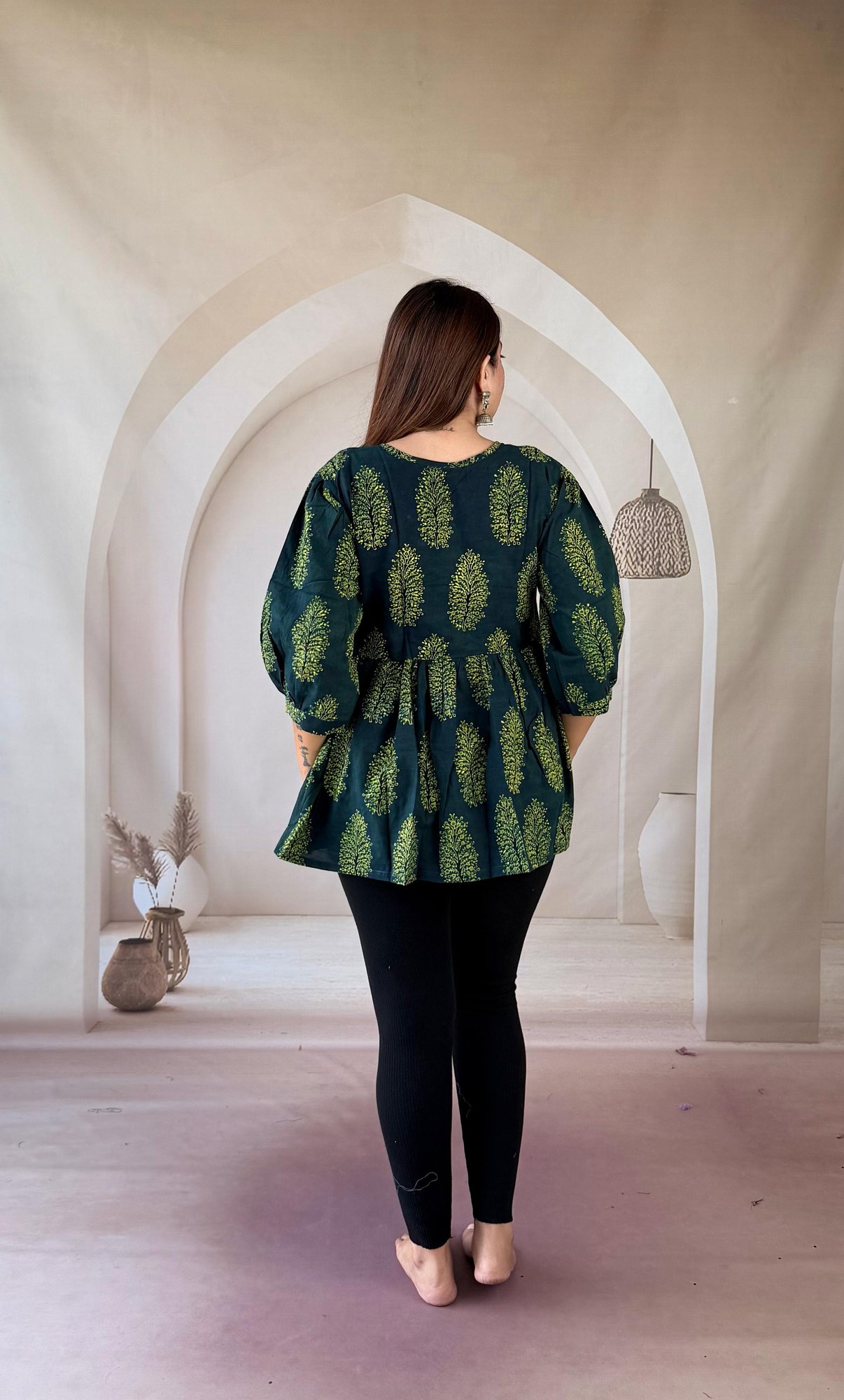 bottle-green-ajrakh-cotton-peplum-kurti-tree-buti-3 Back view of bottle green Ajrakh peplum short kurti with puffed sleeves