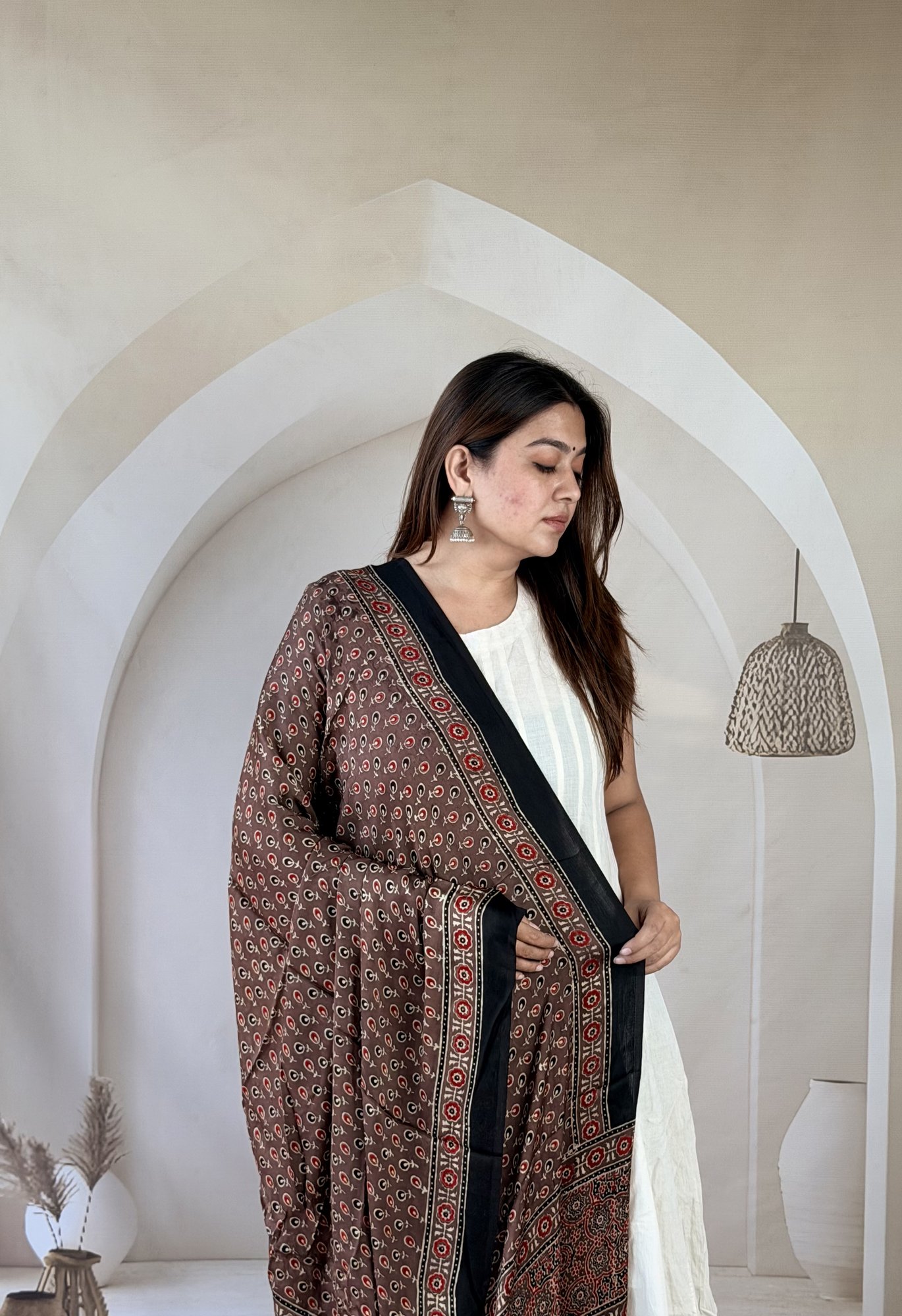 brown-ajrakh-modal silk-dupatta-mini-motif-medallion-3 Close-up of brown Ajrakh modal silk dupatta with tiny motif jaal and red rosette border