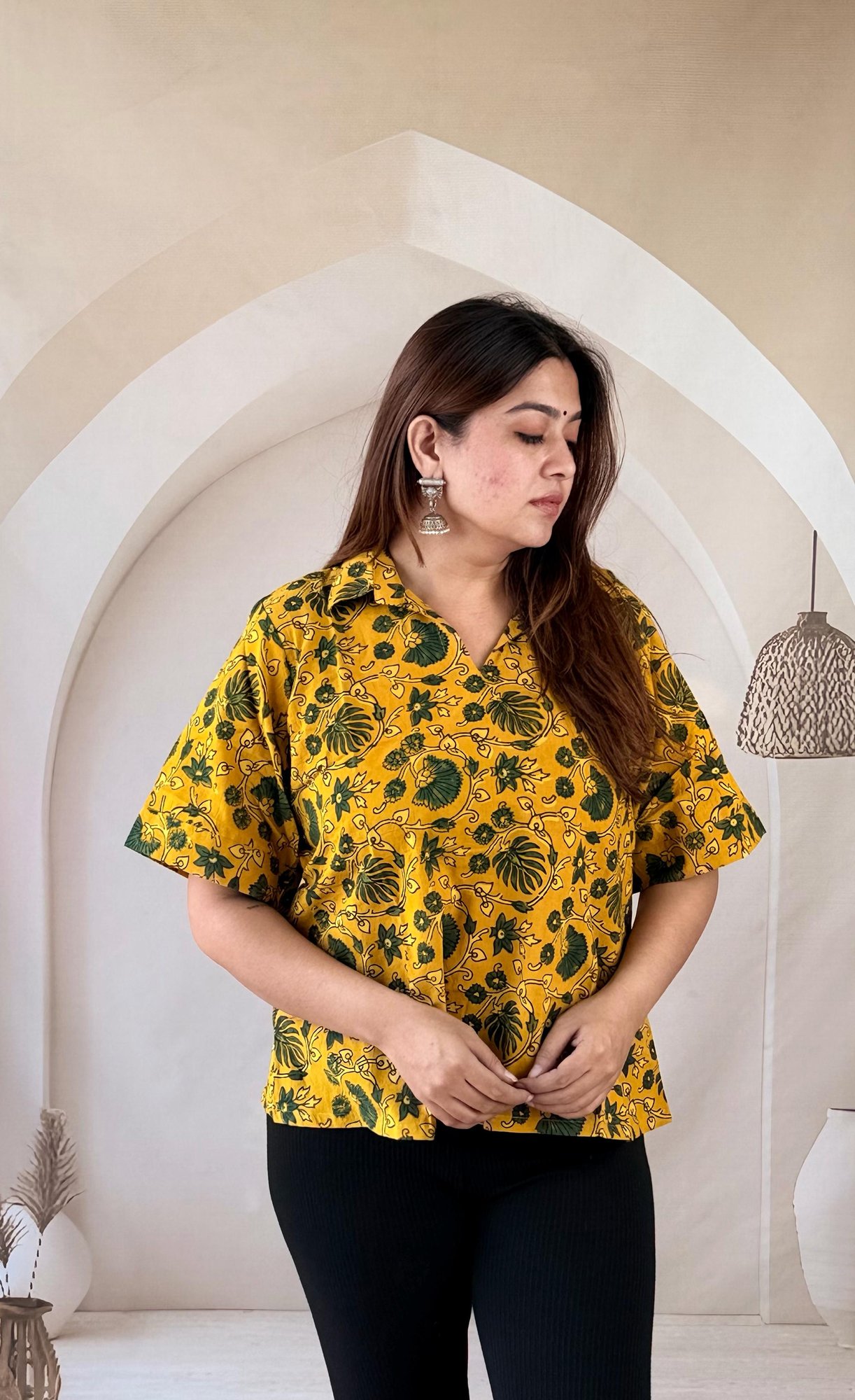 mustard-ajrakh-cotton-short-kurti-collar-neck-2 Close-up of mustard yellow Ajrakh cotton short kurti showing shirt collar and green floral print