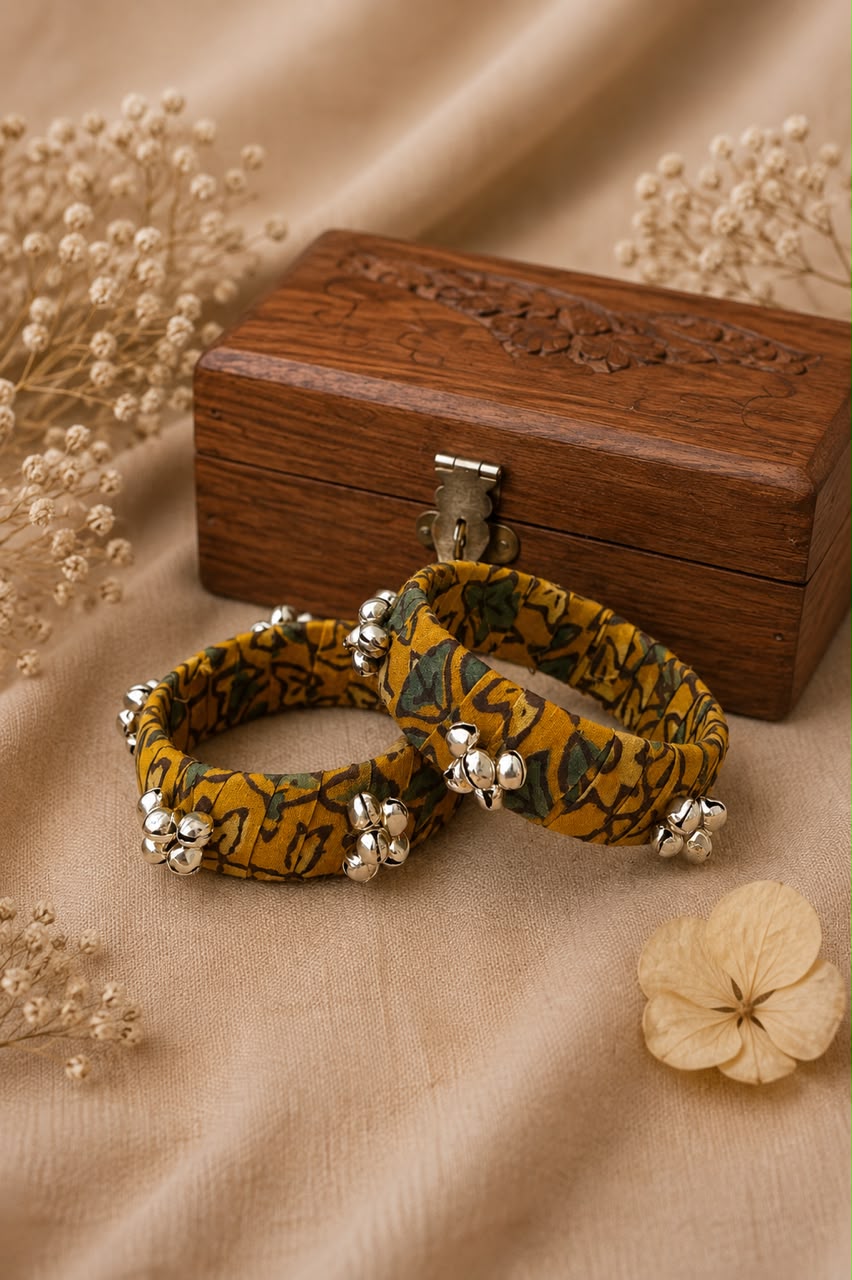 mustard-ajrakh-fabric-bangles-silver-ghungroo Handcrafted mustard Ajrakh fabric bangles with silver ghungroo bell clusters, set of 2