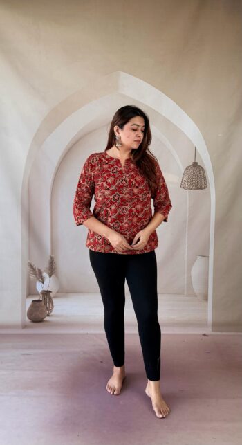 Full-length front view of red Ajrakh cotton short kurti styled with black leggings